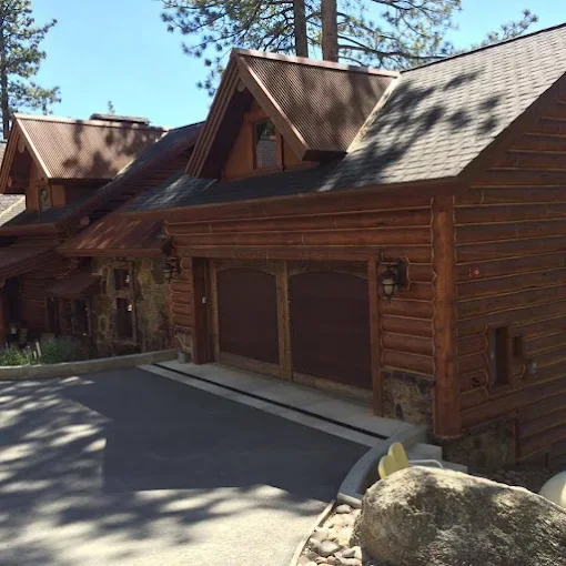 Log home with freshly finished wood siding and stone accents