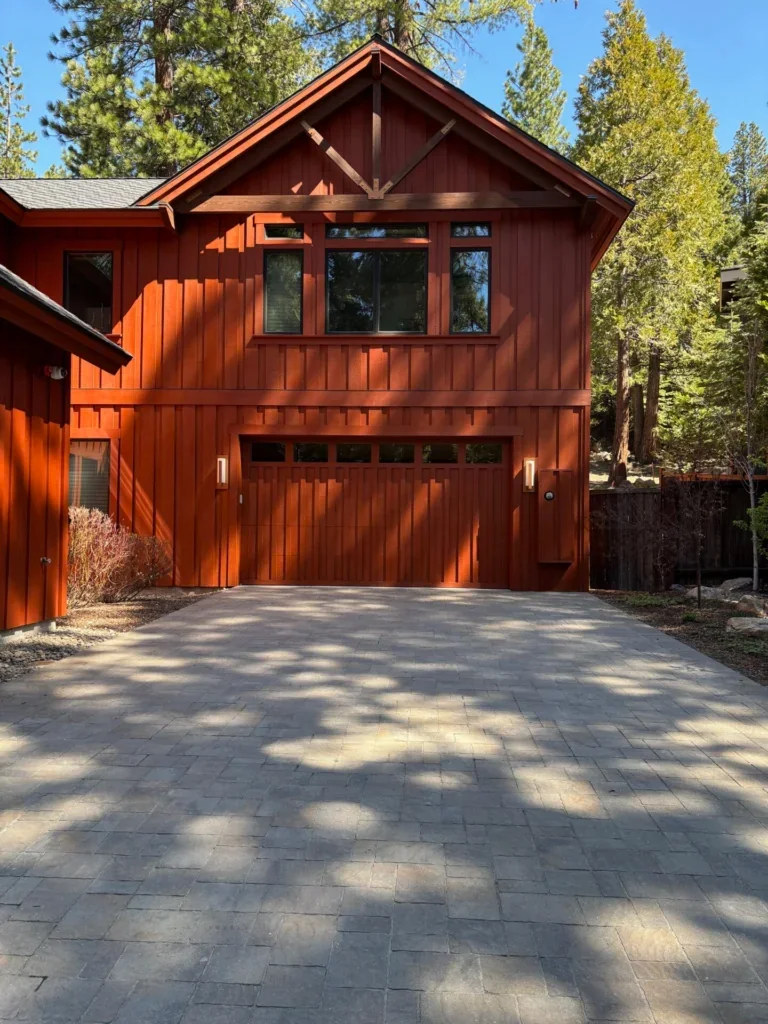 Cabin with freshly stained warm red cedar siding and garage