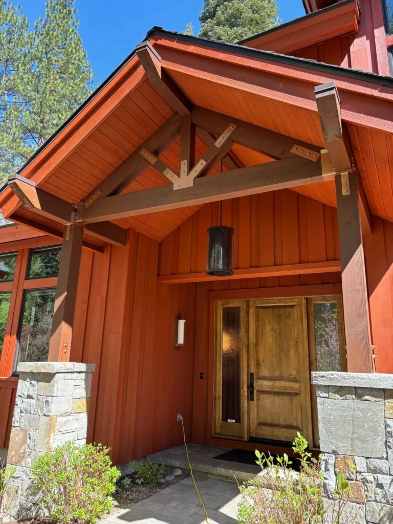 Stained timber and cedar entryway with stone columns