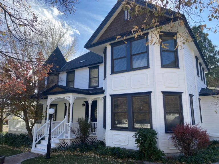Historic Victorian home repainted crisp white with black trim
